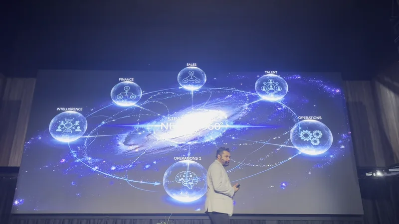 Karloz Vázquez durante una conferencia con una pantalla sobre sistemas empresariales
